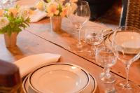 a table with glasses and plates and flowers on it at Château de Boucéel - Mont Saint Michel in Vergoncey