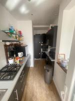 a kitchen with black cabinets and a stove top oven at Bruxelles quartier haut standing in Brussels