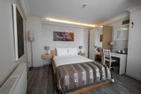 A bed or beds in a room at Elanaz Hotel