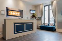 a living room with a fireplace and a blue couch at Best Western Hotel De La Plage Saint Marc sur Mer in Saint-Nazaire