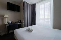 a hotel room with a bed and a desk and a window at Best Western Hotel De La Plage Saint Marc sur Mer in Saint-Nazaire