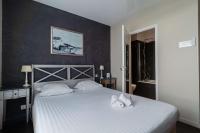 a bedroom with a bed with two towels on it at Best Western Hotel De La Plage Saint Marc sur Mer in Saint-Nazaire