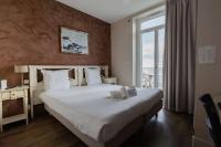 a bedroom with a large white bed with a window at Best Western Hotel De La Plage Saint Marc sur Mer in Saint-Nazaire