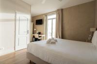 a bedroom with a large white bed with a window at Best Western Hotel De La Plage Saint Marc sur Mer in Saint-Nazaire