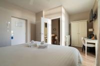 a bedroom with a white bed and a desk at Best Western Hotel De La Plage Saint Marc sur Mer in Saint-Nazaire