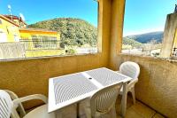 a table and chairs on a balcony with a view at E20 Les Naïades- 2 bedrooms for 5 people ! in Avène