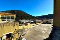 a view of a building with a mountain in the background at E20 Les Naïades- 2 bedrooms for 5 people ! in Avène