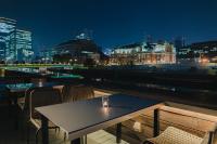 a table and chairs on a balcony at night at THE BOLY OSAKA in Osaka