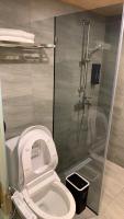 a bathroom with a white toilet and a shower at Dafong Hotel in Zhongzheng