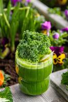 a green plant in a cup with some flowers at Warsaw Presidential Hotel in Warsaw