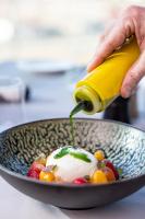 a person is pouring a drink into a bowl of food at Warsaw Presidential Hotel in Warsaw