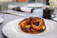 a plate of food with shrimp and vegetables on a table at Warsaw Presidential Hotel in Warsaw