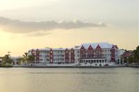 a group of buildings next to a body of water at Ramada by Wyndham Tikal Isla de Flores in Flores