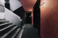 a hallway with stairs and a black door at Boutique Hotel OLOM - Only Adults recommended in Cádiz