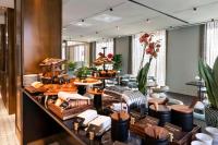 a buffet line with bread and pastries in a restaurant at Radisson Collection Hotel, Roma Antica in Rome
