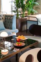 a table with a tray of food and drinks on it at Radisson Collection Hotel, Roma Antica in Rome