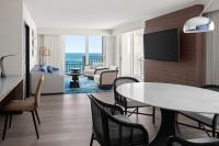 a living room with a table and chairs at San Juan Marriott Resort and Stellaris Casino in San Juan