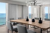 a dining room with a wooden table and chairs at San Juan Marriott Resort and Stellaris Casino in San Juan
