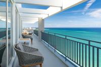 a balcony with chairs and a view of the ocean at San Juan Marriott Resort and Stellaris Casino in San Juan