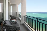 a balcony with chairs and a view of the ocean at San Juan Marriott Resort and Stellaris Casino in San Juan