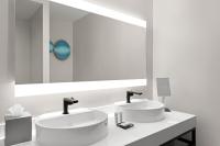 a bathroom with two sinks and a large mirror at San Juan Marriott Resort and Stellaris Casino in San Juan