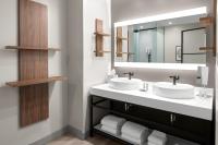 a bathroom with two sinks and a mirror at San Juan Marriott Resort and Stellaris Casino in San Juan