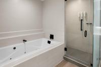 a white bathroom with a tub and a shower at San Juan Marriott Resort and Stellaris Casino in San Juan