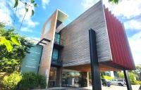 a building with a sign in front of it at Phillip Island Apartments in Cowes