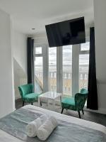 1 dormitorio con 1 cama con 2 sillas y TV en WNS Southend-on-Sea, en Southend-on-Sea