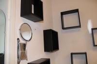 a wall with a mirror and a speaker and a mirror at City Lodge Appart Hôtel Niort in Niort