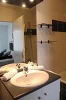 a bathroom with a sink and a shower with a mirror at City Lodge Appart Hôtel Niort in Niort