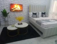 a small room with a bed and a table at Stylish villa homes in Mombasa