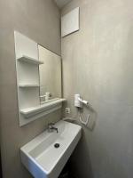 a bathroom with a white sink and a mirror at F Hotel in Hörsching