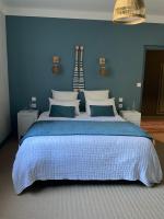 a bedroom with a large bed with a blue wall at Chambres d&#39;hôtes Le Montagné in Villeneuve-lès-Avignon