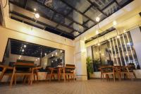 a group of tables and chairs in a restaurant at Hotel Pavitra in Pūrnia