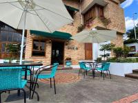 a patio with tables and chairs and umbrellas at Valle de Santiago Hotel Boutique in San Cristóbal