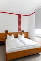 a bed in a room with a sign above it at Hotel Anker in Saalfeld