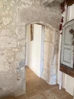 a hallway in a castle with a stone wall at Maison d hôtes Les Chantours dans réserve naturelle 15 hectares in Saint-Antoine-Cumond