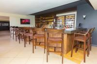 a bar with wooden stools in a restaurant at Southgate Residence Serviced Apartments in Nairobi