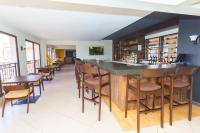 a bar in a restaurant with wooden tables and chairs at Southgate Residence Serviced Apartments in Nairobi