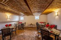 a dining room with tables and chairs with red flowers on them at Hotel PrincesSophie in Sighişoara