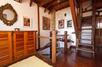 a room with a staircase and a mirror on the wall at Pousada Arte Urquijo in Paraty