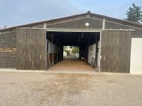 a large wooden barn with an open door at Mas de la pie in Saintes-Maries-de-la-Mer