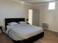 a bedroom with a bed with two pillows on it at Maison de village in Lédenon