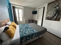 a bedroom with a bed and a painting on the wall at Le Richelieu Bacchus in Fontainebleau