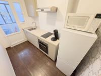 a white kitchen with a sink and a microwave at Le Cavaignac -2 chambres proche de Saint Charles in Marseille