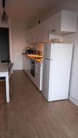 a kitchen with a white refrigerator and a table at STUDIO BANDOL 2 Etoiles Climatisé in Bandol