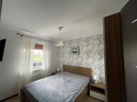 Posteľ alebo postele v izbe v ubytovaní Apartament Ogrody