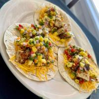 two tacos on a plate with salsa and cheese at Riverview Hotel in Saint Marys