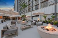 a patio with couches and a fire pit in front of a building at Hilton Irvine/Orange County Airport in Irvine